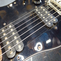 <p>Standard Series Squier Stratocaster with 2 x humbucking pickups, tremolo system, '70s style headstock, and more.</p><p>Condition: The 'Squier' logo has been scraped off the headstock!&nbsp; There are a few small scuffs , but otherwise it's very good.</p>